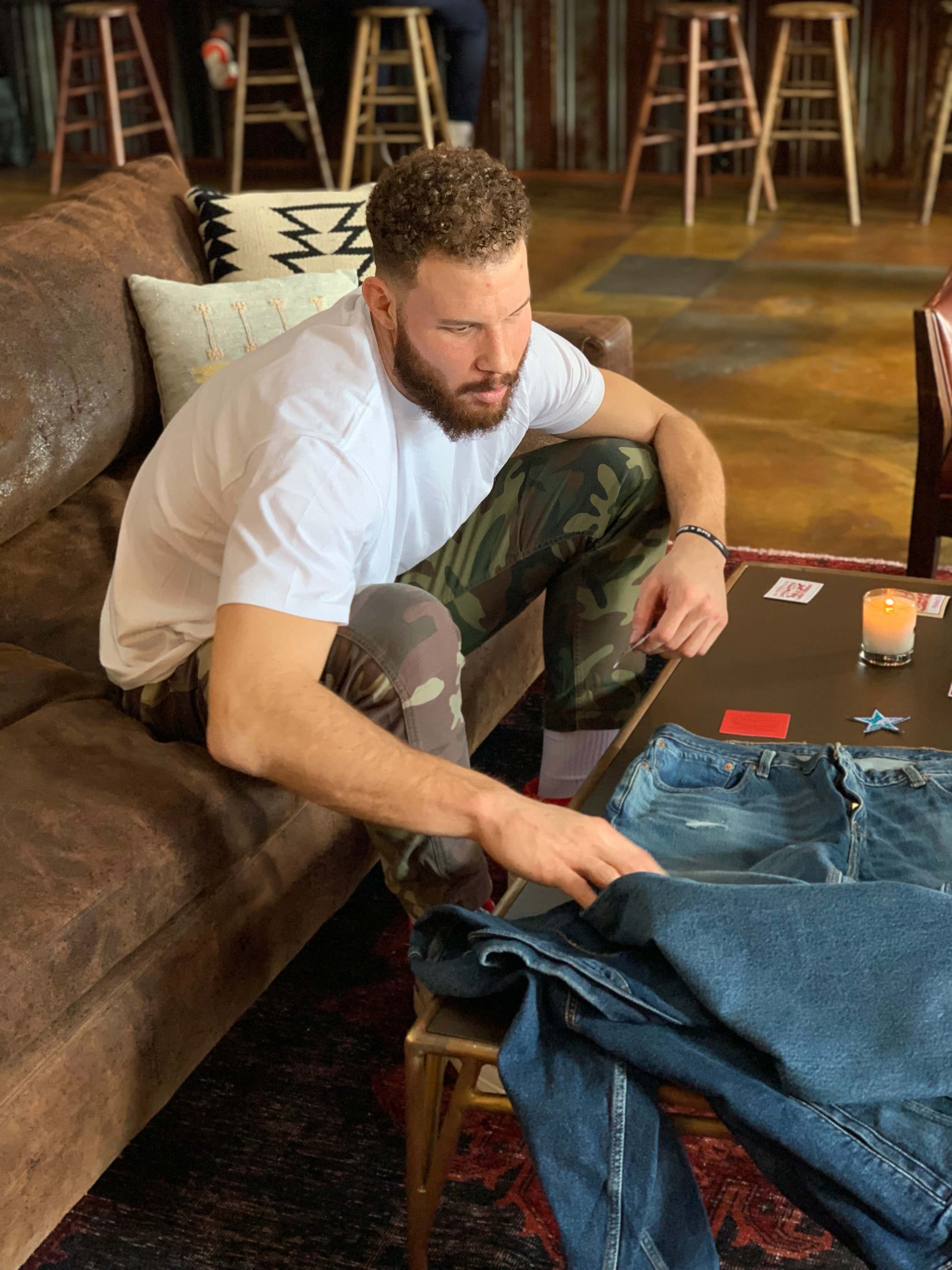 Blake Griffin looking at Levi's Jeans on table